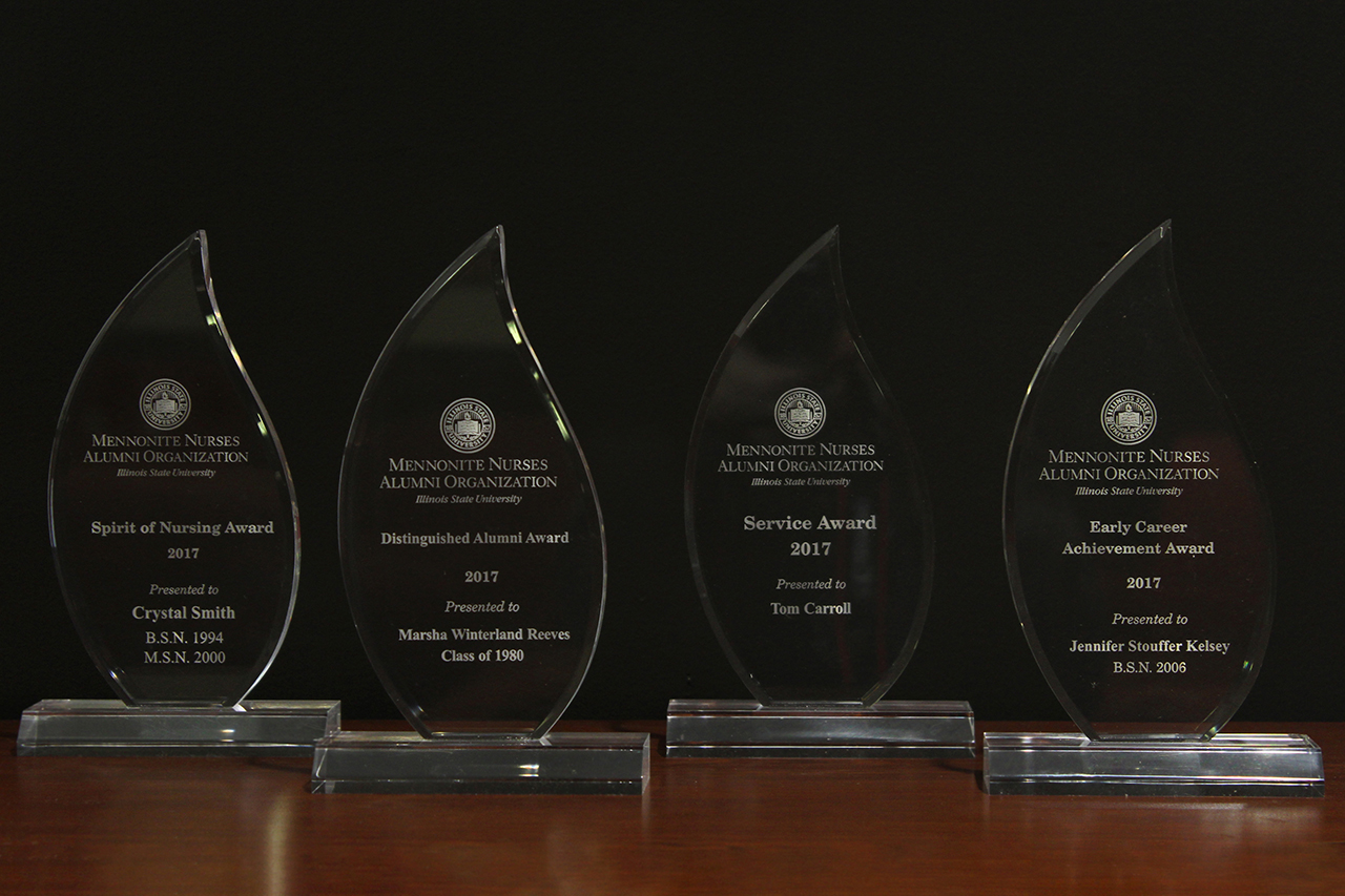Four awards on a table
