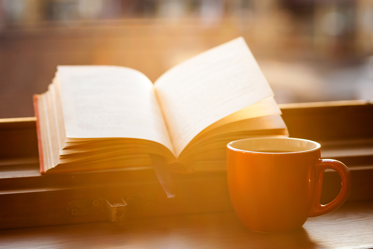 image of Books and a coffee cup on a windowsill