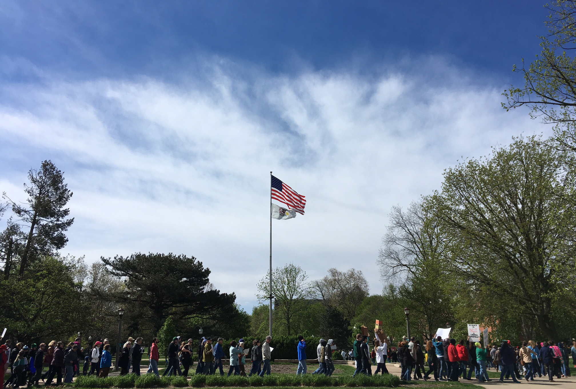 Marchers pass by the flagpole on Illinois State's Quad during the March for Science in Normal. (Photo by Megan Kathol Bersett)