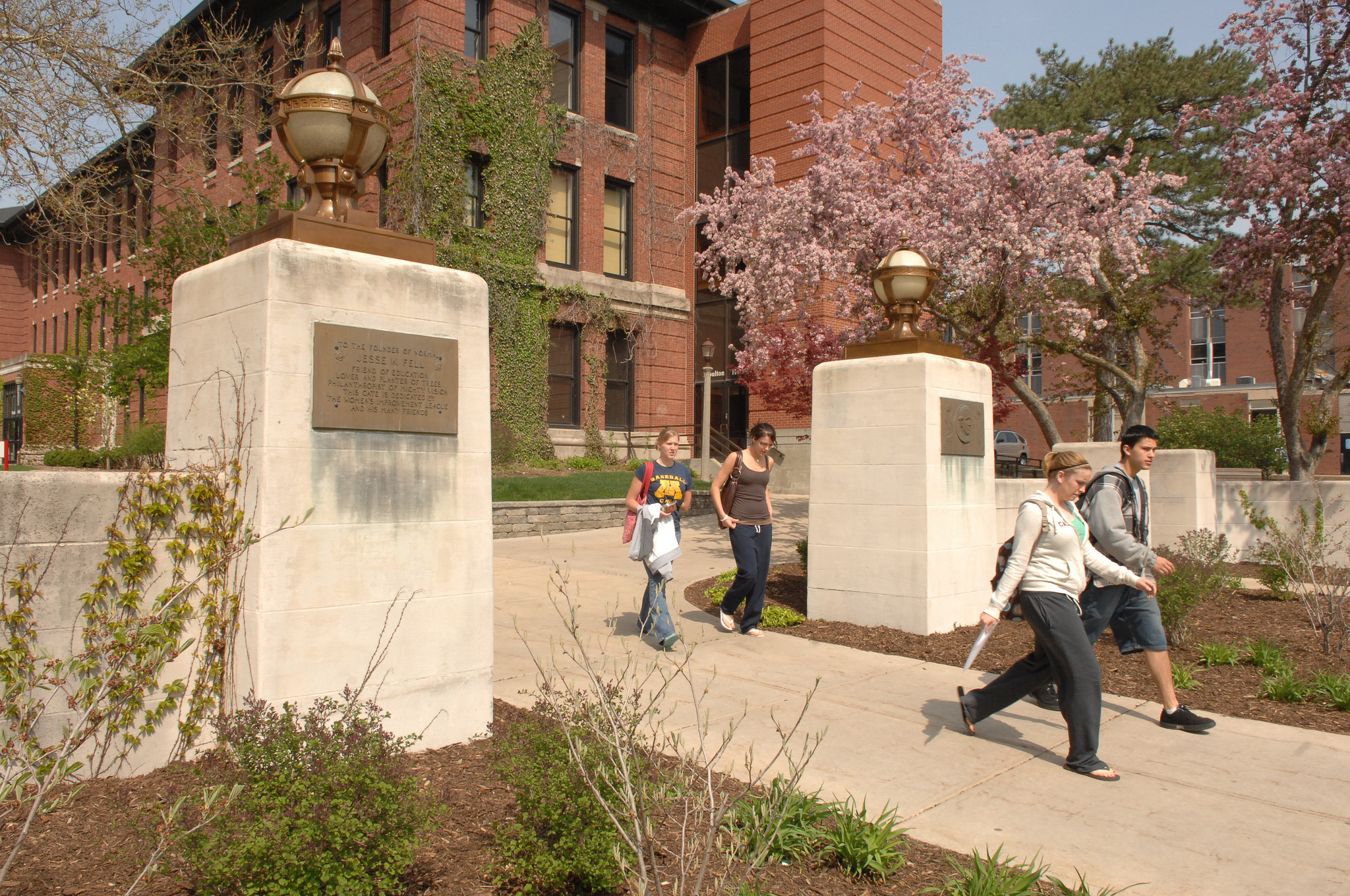 Students stroll onto the Quad past the Fell gates in the spring.