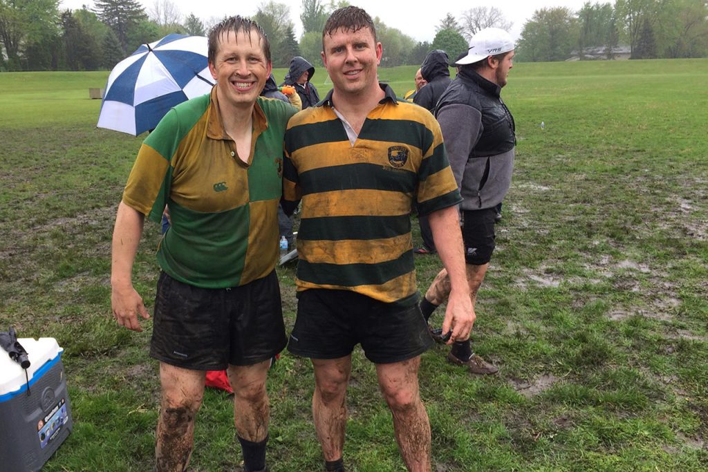 Club rugby alumni celebrate after a muddy match against current students at the 45th anniversary reunion in 2016.