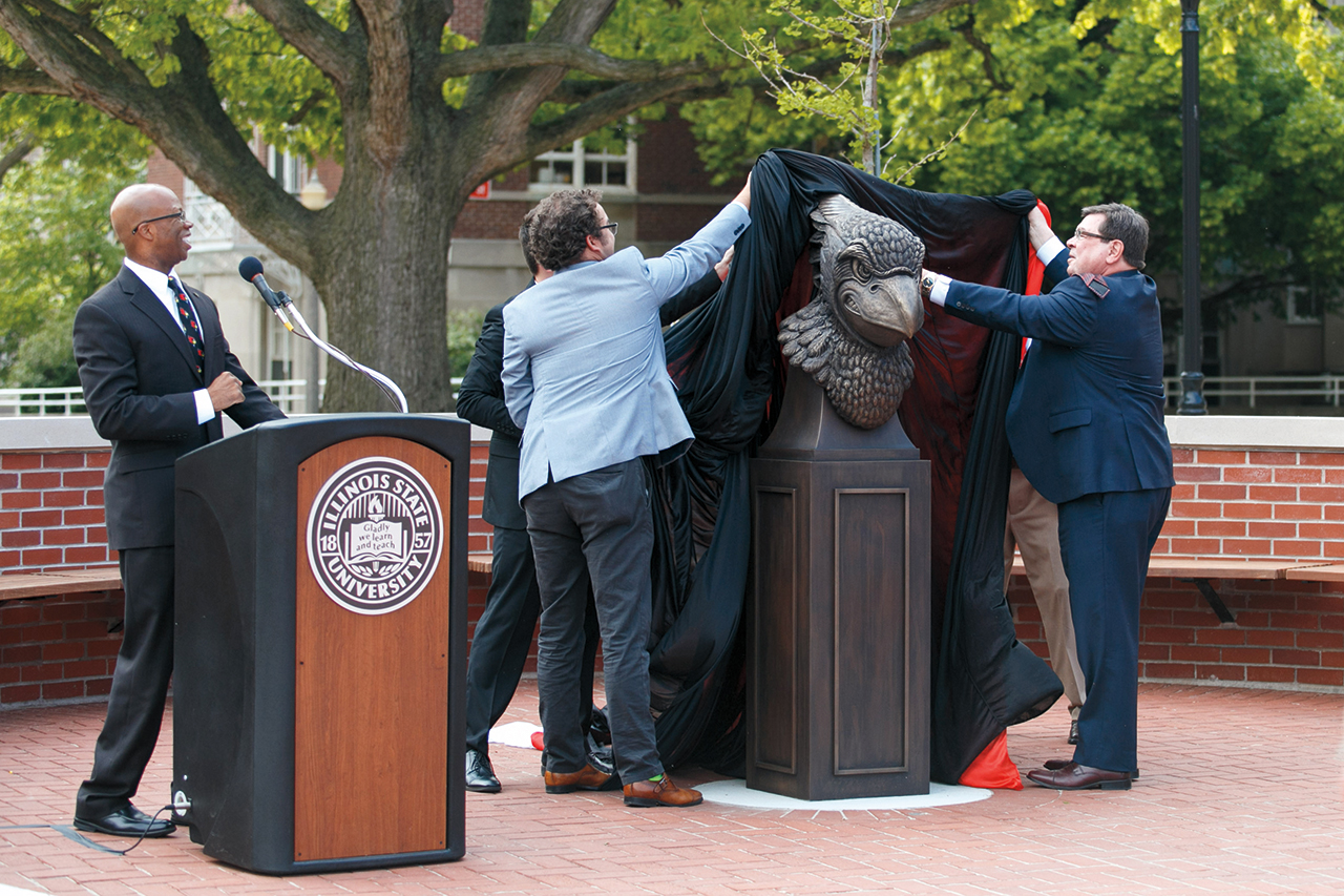 President Larry Dietz, right, and student trustee, Ryan Powers, center, assisted in the unveiling of the plaza statue. Vice President for Student Affairs Levester Johnson gave the countdown.
