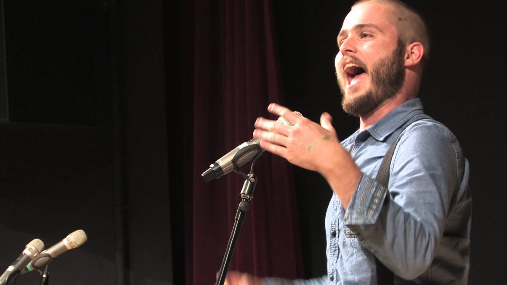 Slam poet Neil Hilborn performing at a mic