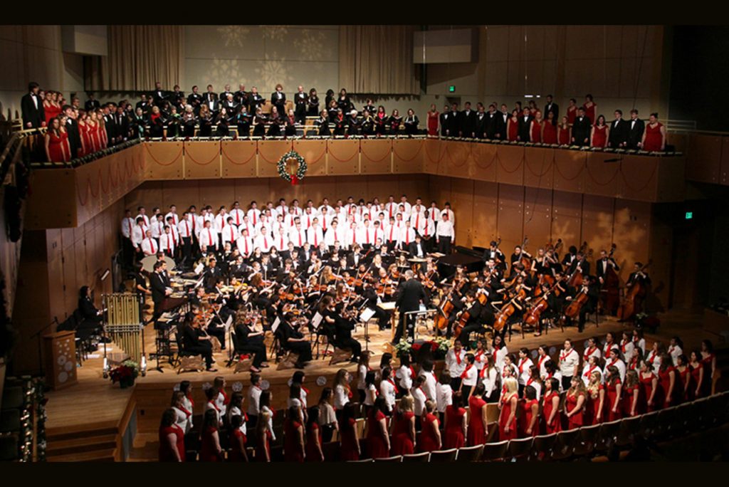 Photo of a previous Music for the Holidays concert with a combined orchestra and choirs on stage.