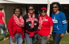 Four women smile at tailgate