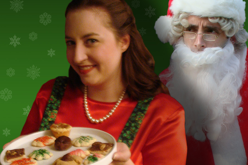 Woman with cookie and Santa Claus behind her.