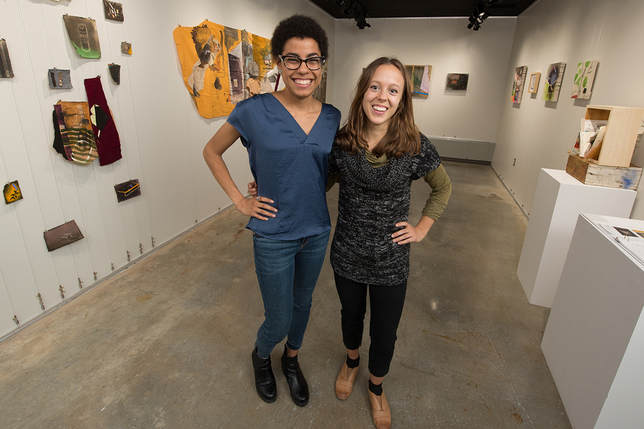 Whitney Johnson and Alissa Palmer pose in the gallering featuring their work.