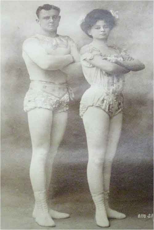 photo of couple standing in aerialists uniforms
