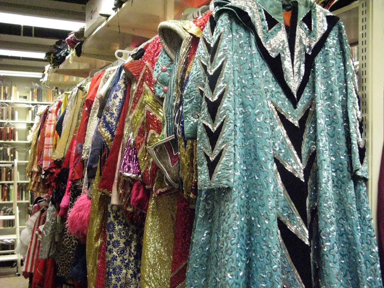 Glittery costumes hanging on a rack