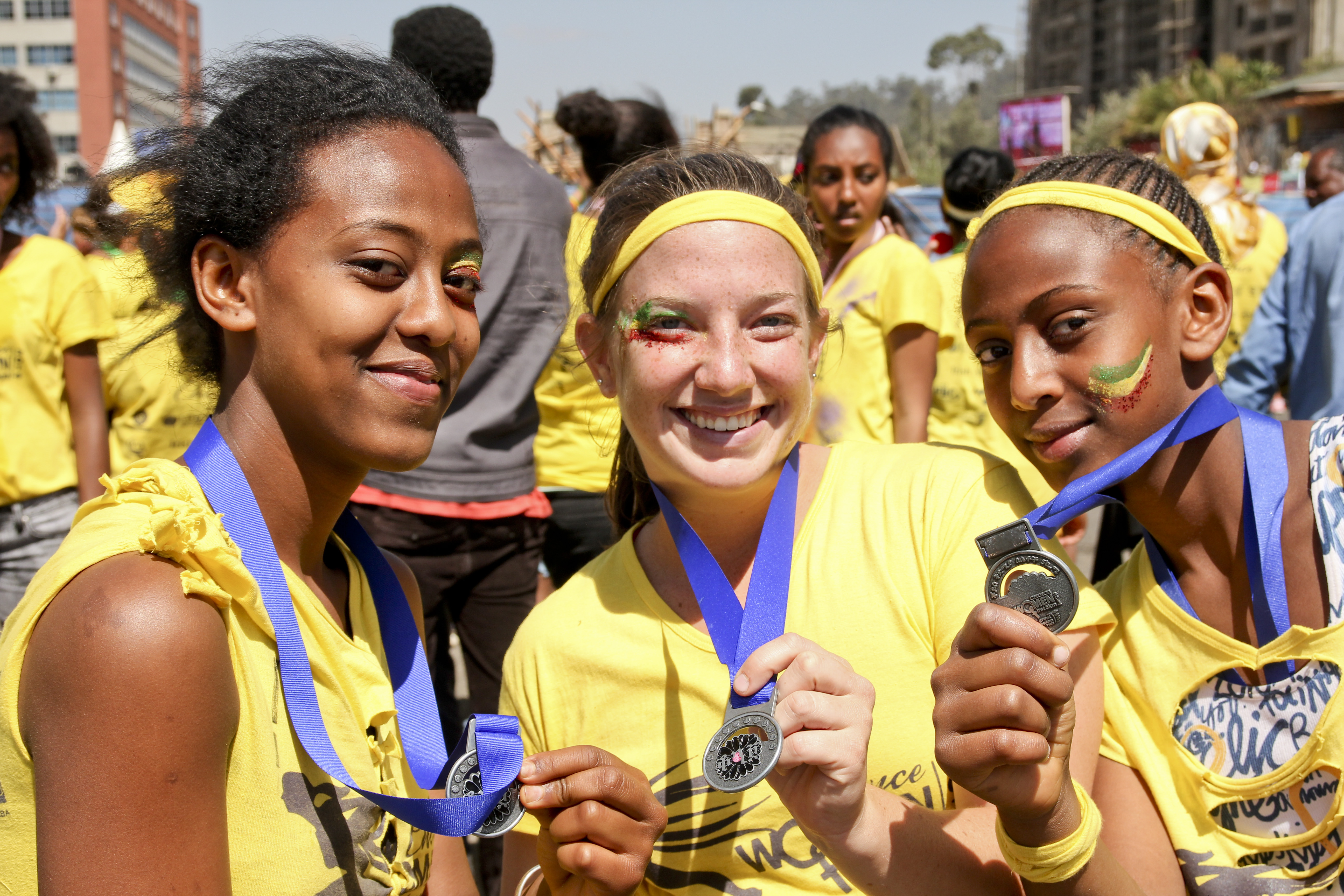 Lauren and two students holding race medals