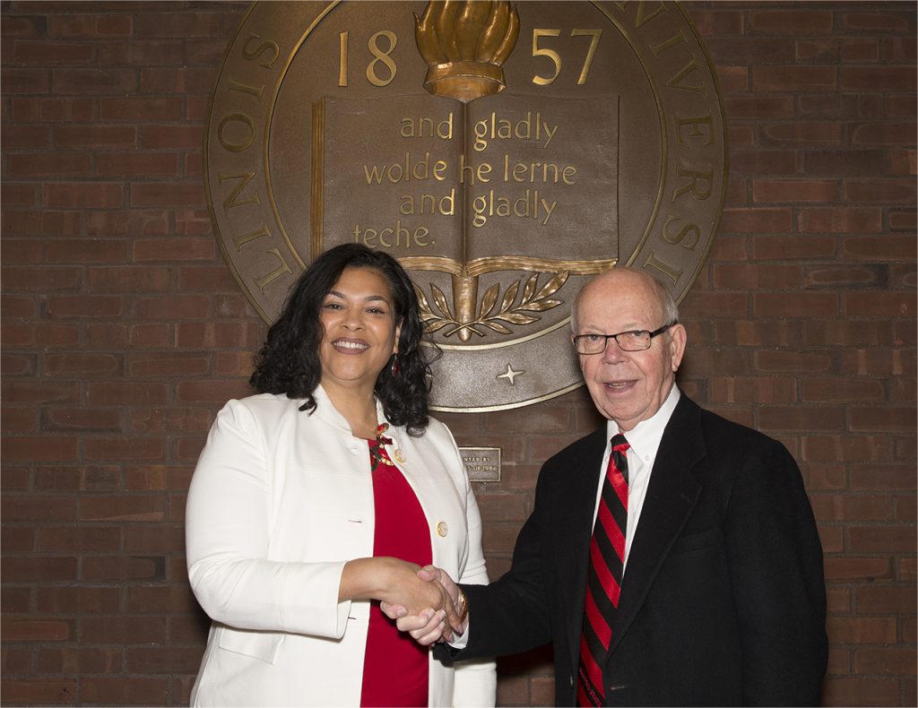 Doris Houston and David Strand standing in front of the old ISU seal in the Bone Student Center