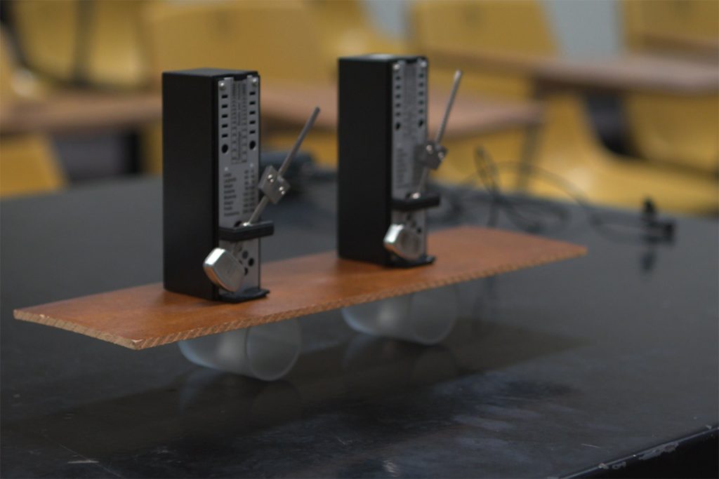 Two black computer modules on a pedestal