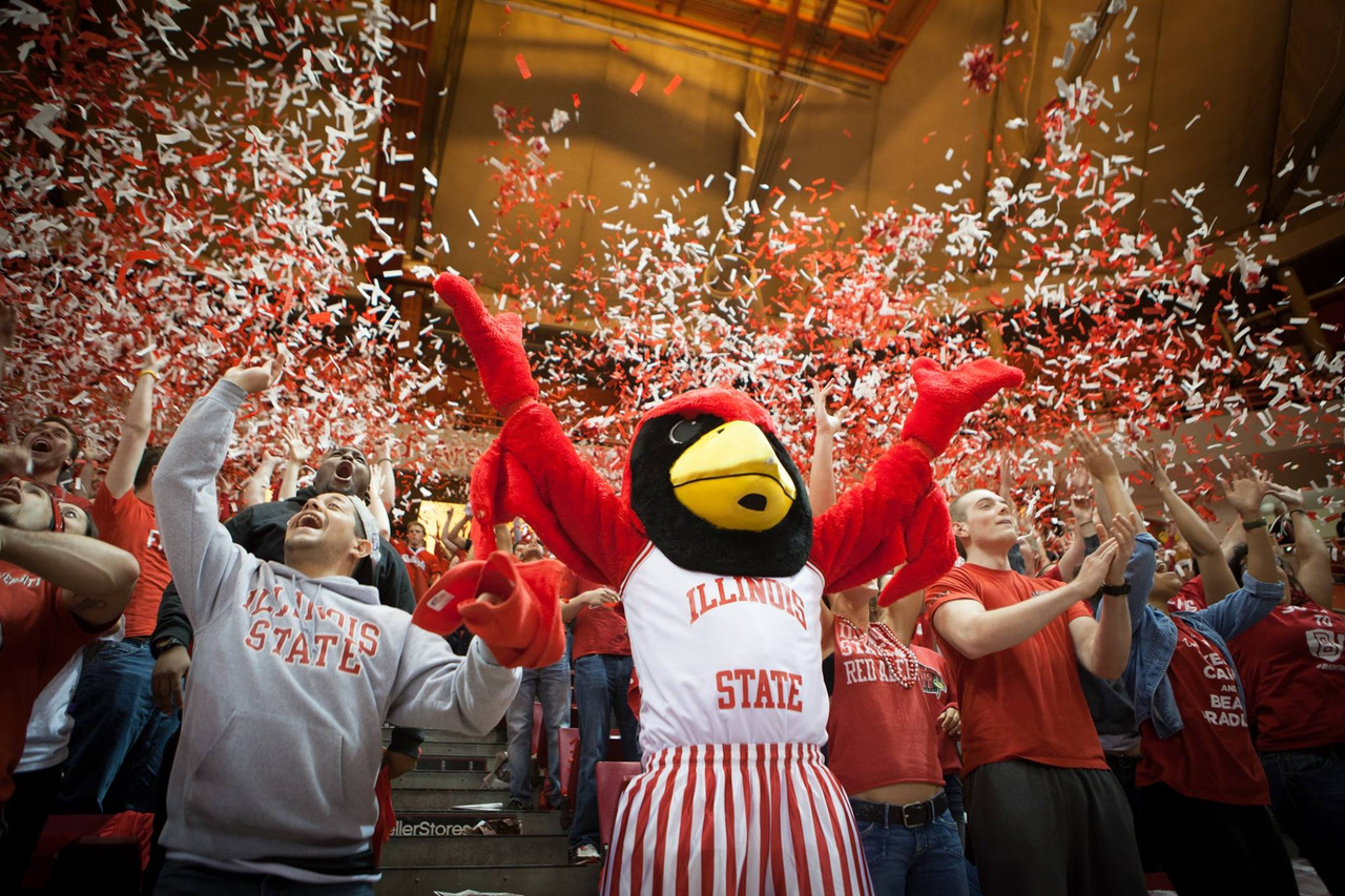 reggie mascot with arms up as confetti falls