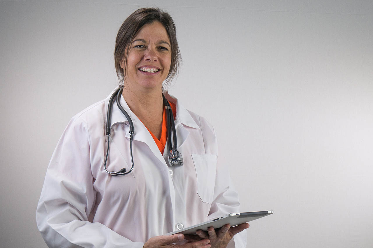 Doctor Nurse with clipboard against a grey background