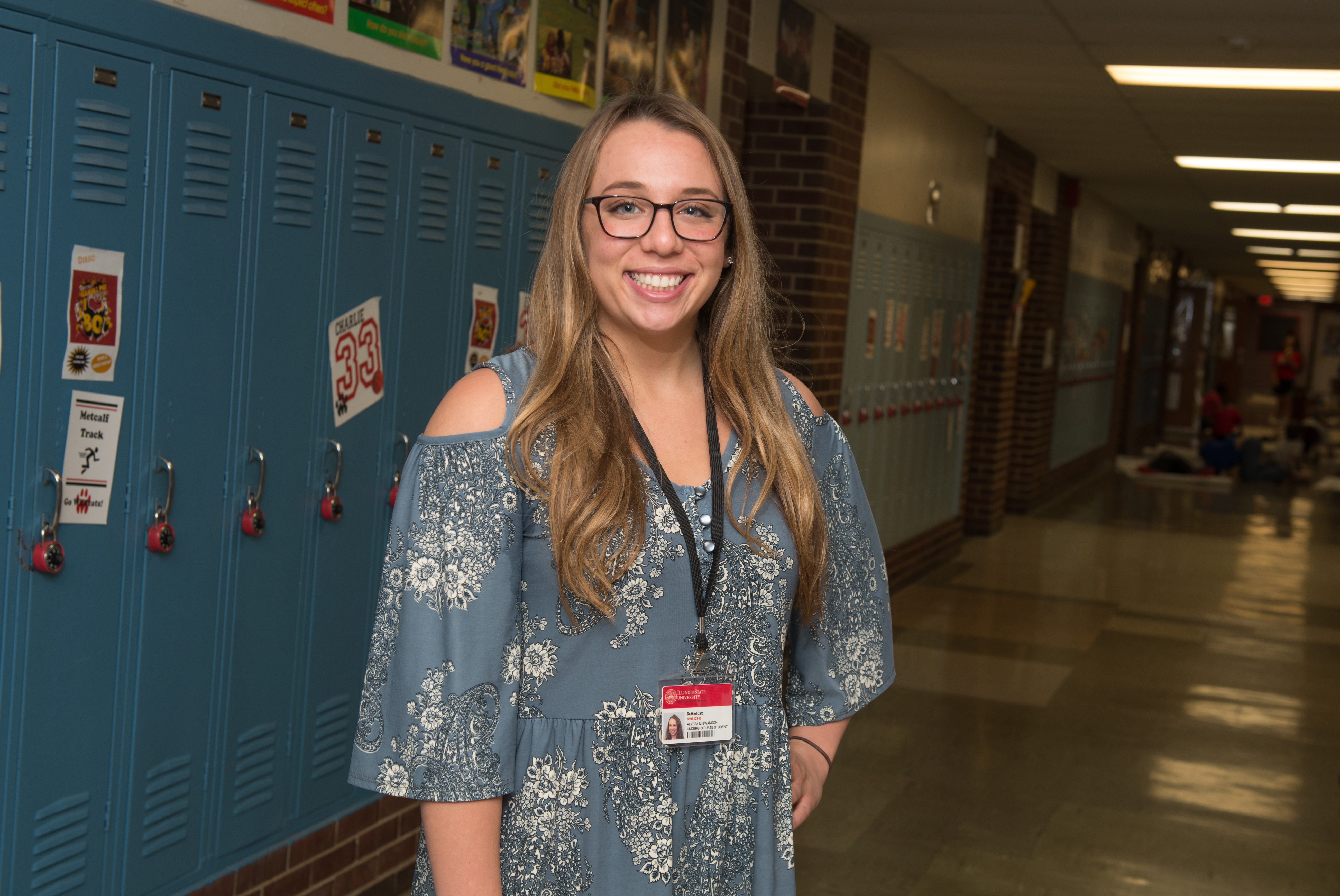 Alyssa Swanson standing in elementary school hallway