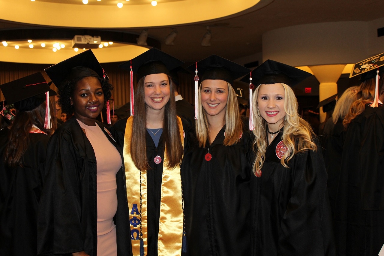 Four MCN Students in caps and gowns