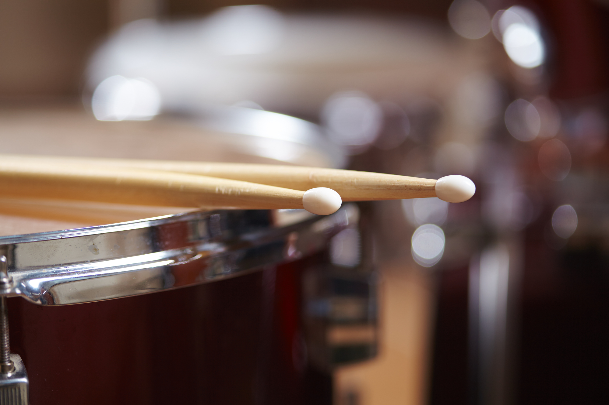 Drums conceptual image with close up of drum rim and drum sticks