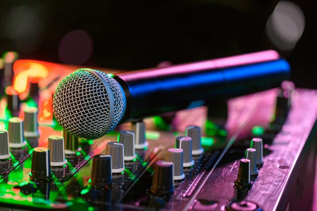 Microphone sitting on a soundboard under dance lights