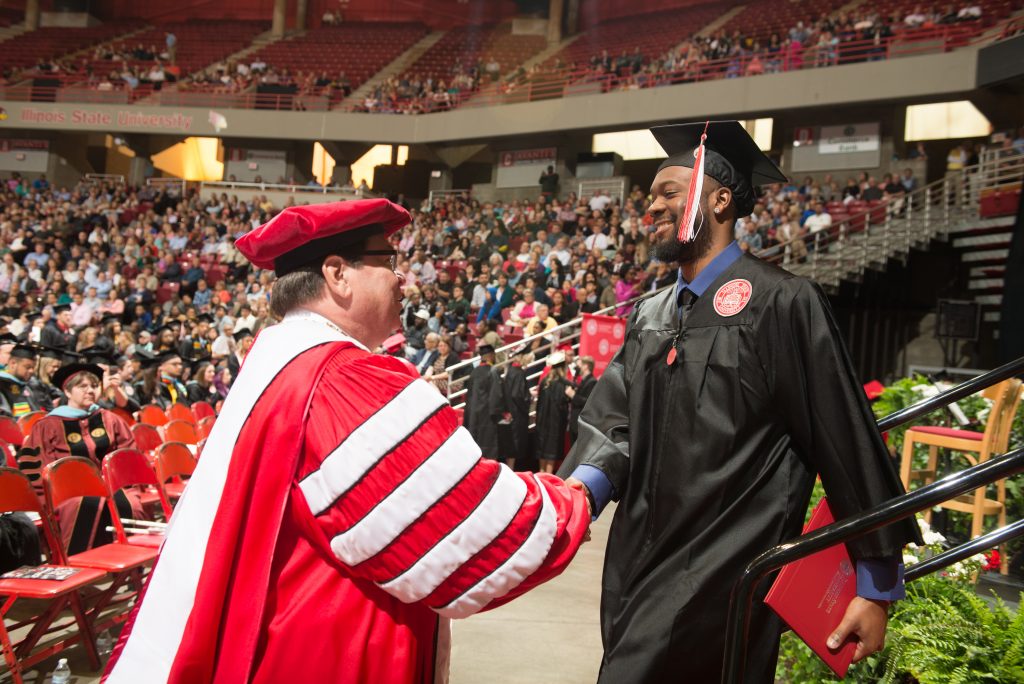 Larry Dietz congratulating a graduate