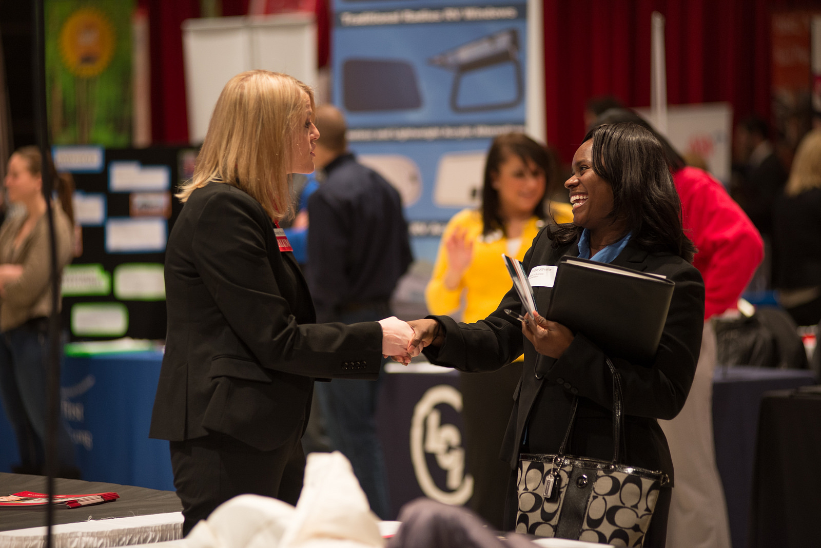 A student talks to a prospective employer at a Career Center job fair