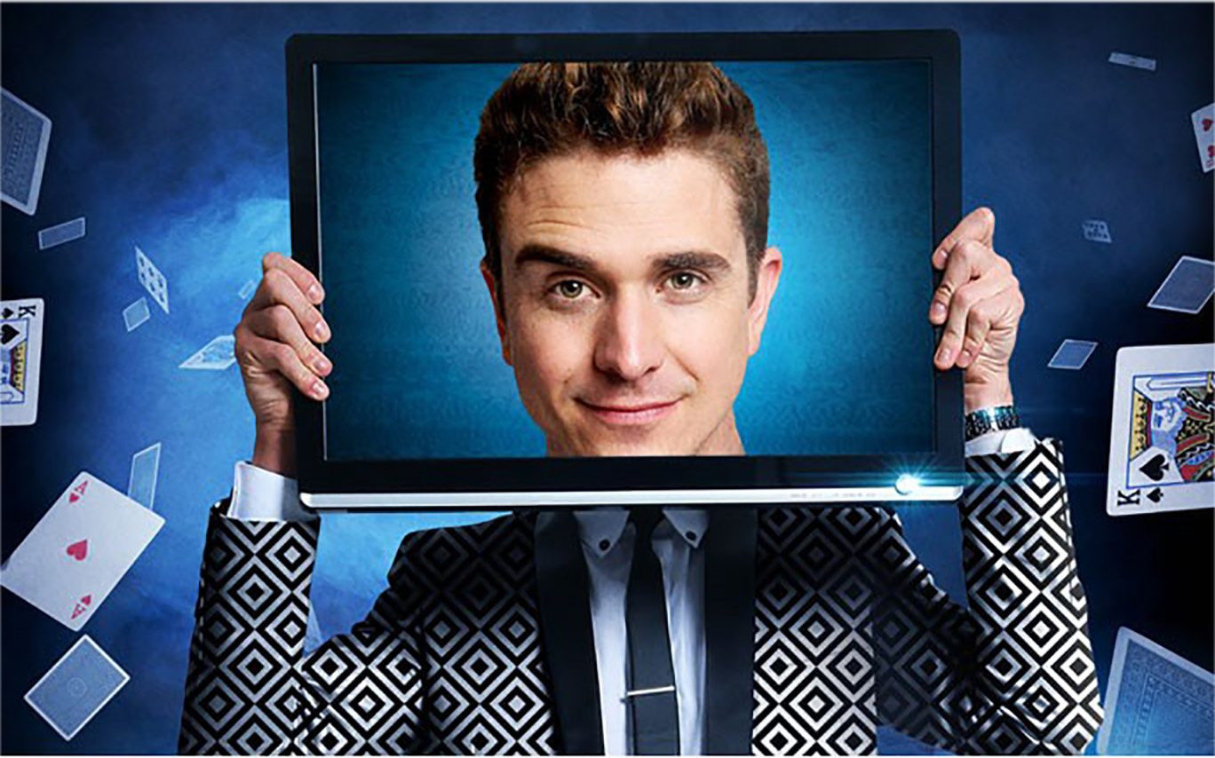 Man holding a TV screen with his face on it