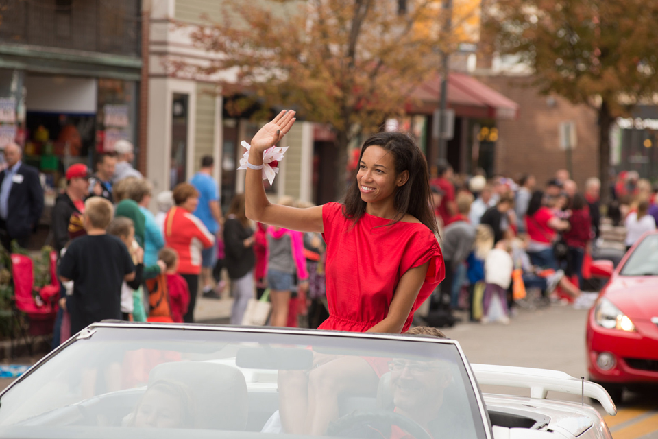 woman waving in convertible car