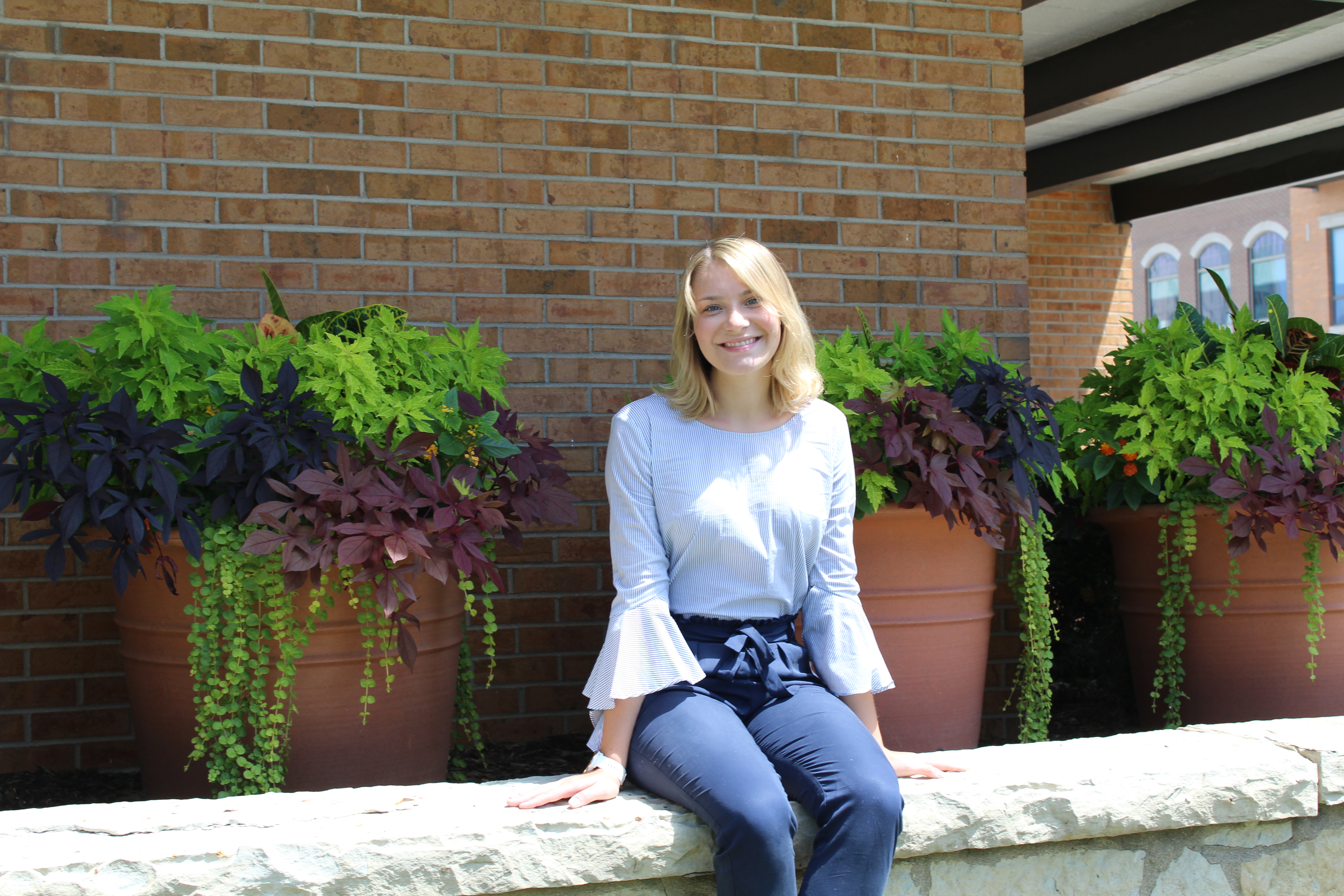 Rachael Wernsman sitting outside the Center for Community Engagement and Service Learning