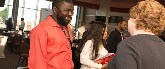 student meeting an employer at a career fairs