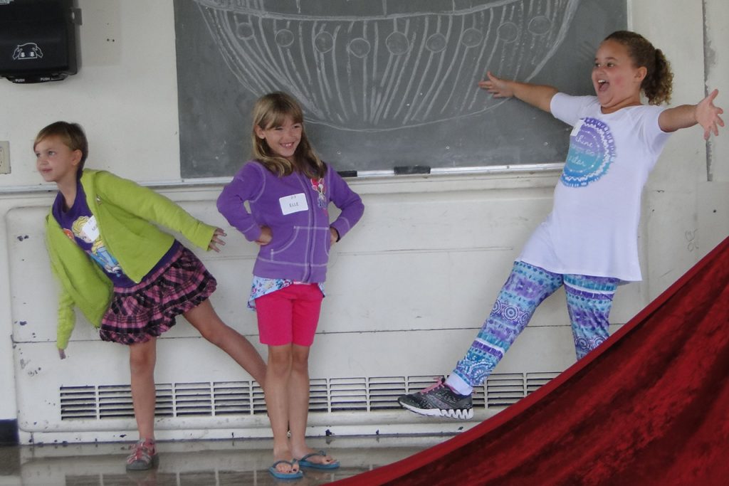 Three children performing during a Saturday Morning Creative Drama class.