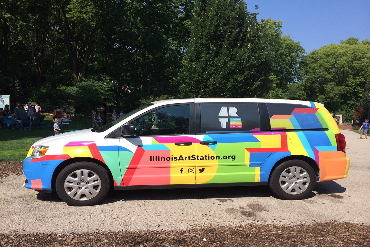 Colorful minivan with "Illinois Art Station" written along the side.