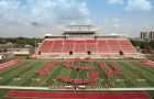 Group of students form the letters 'ISU' on the football field