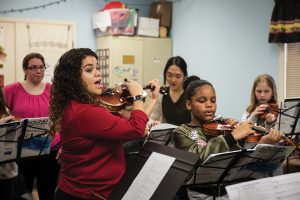 ISU student Adriana Lizardi leads a string music class at Western Avenue Community Center.