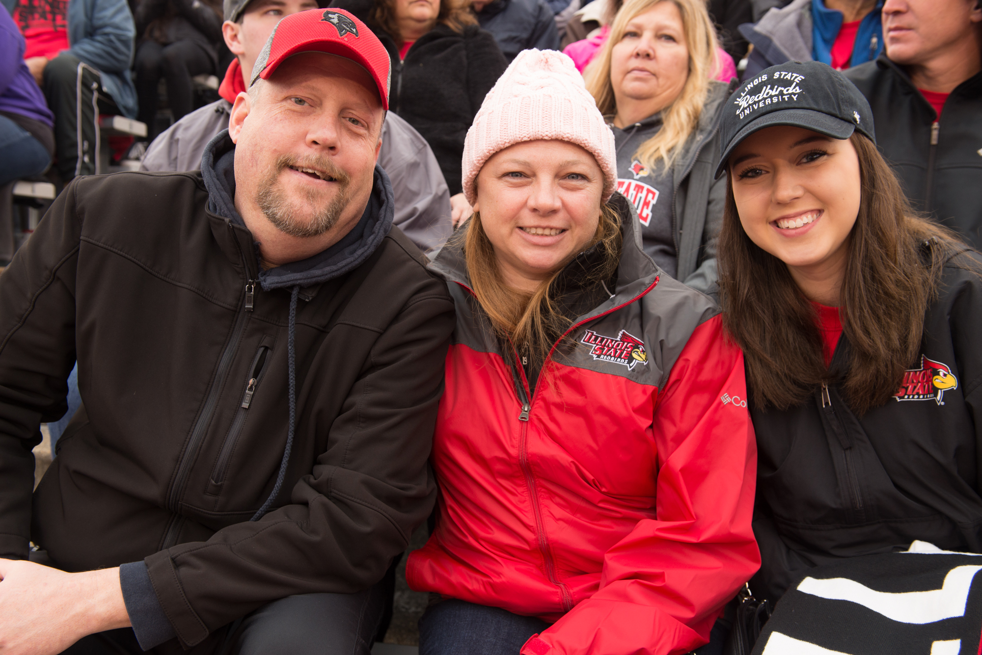 A family poses at the football game during Family Weekend