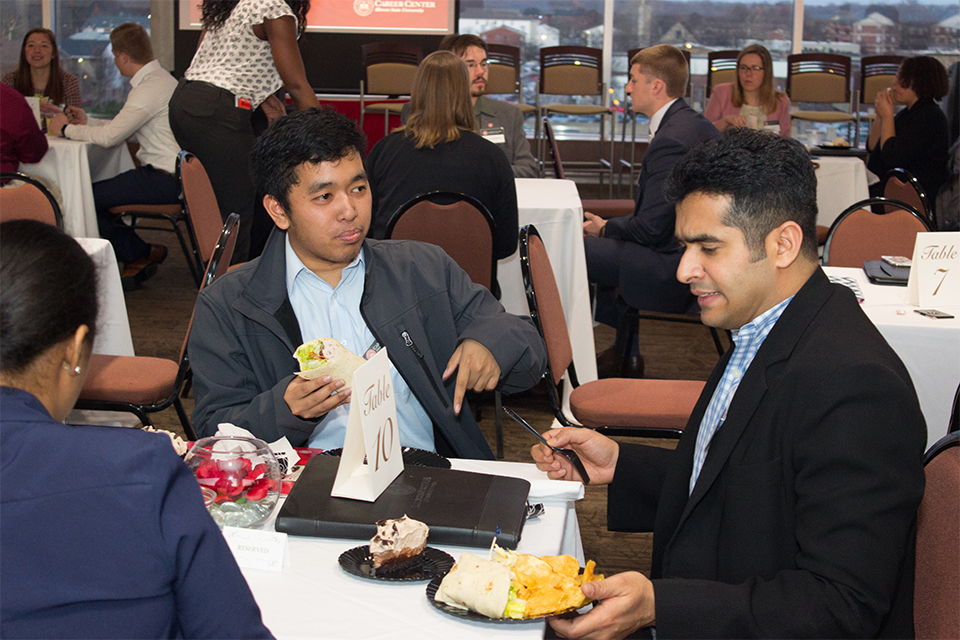 students meet with employers over dinner