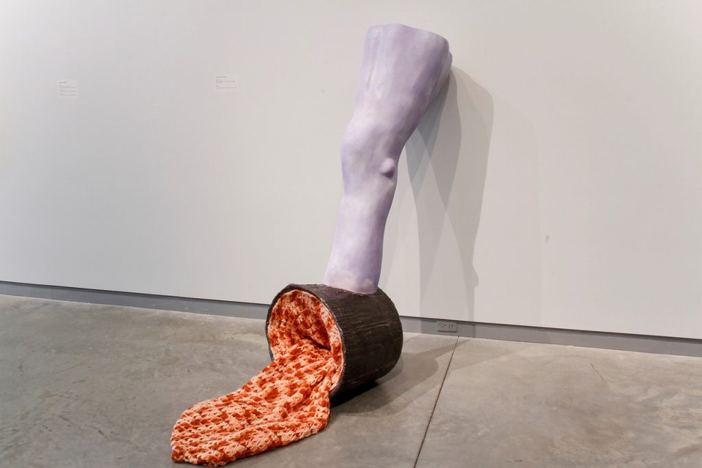 Image of the artwork "Leg (Scoop)." Image appears to be part of a leg coming from a bucket that has been spilled.