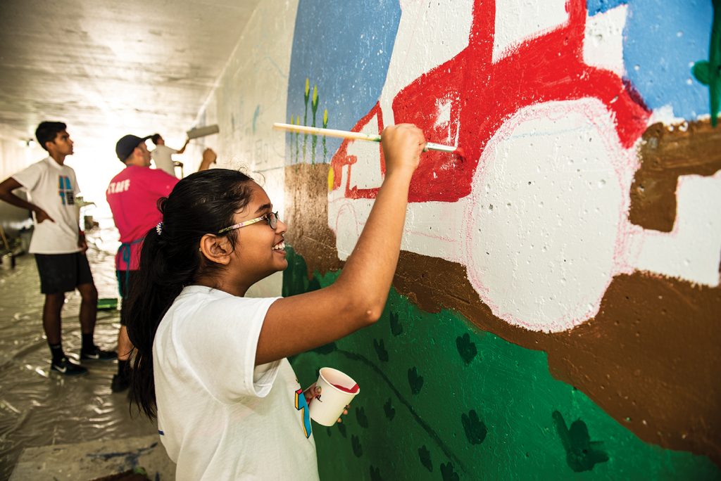 Bloomington-Normal youth paint a mural last summer as part of an Illinois Art Station led project along the Constitution Trail.