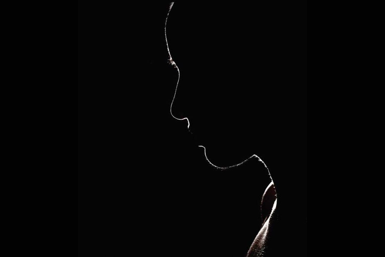 Image from the production poster - the outline of a woman's face against a black background.