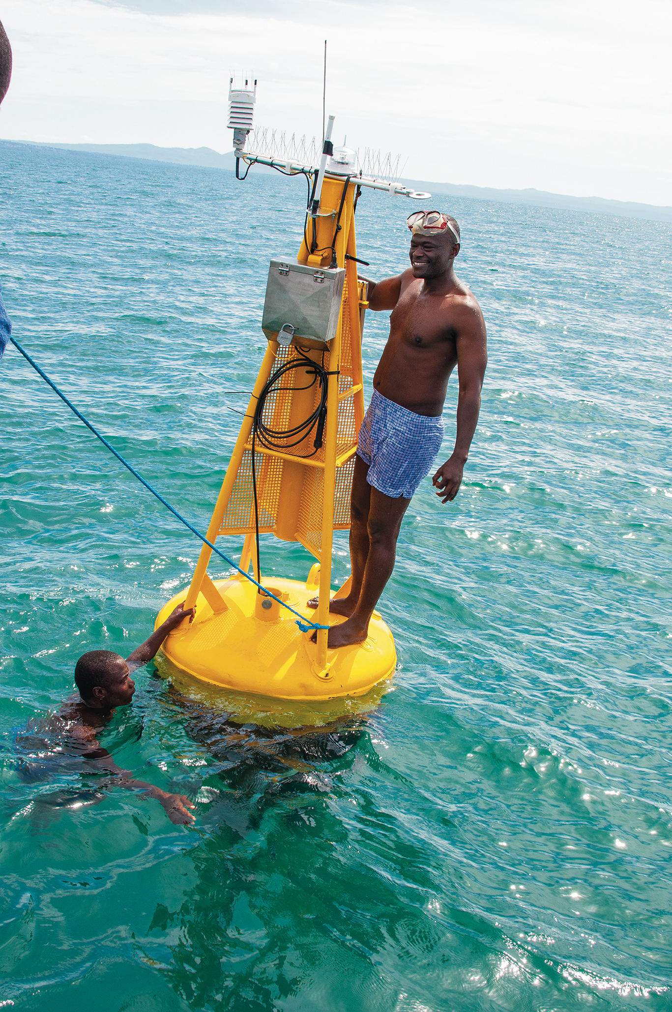 TAFIRI members check the buoy gathering temperature measurements in Lake Tanganyika.