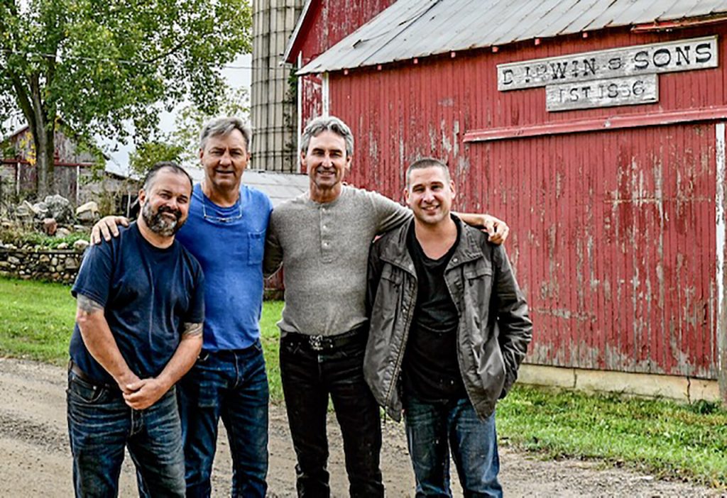 Jim Irwin (far right) with American Pickers hosts Frank Fritz (left), Robbie Wolfe, and Mike Wolfe at the Irwins' farm.