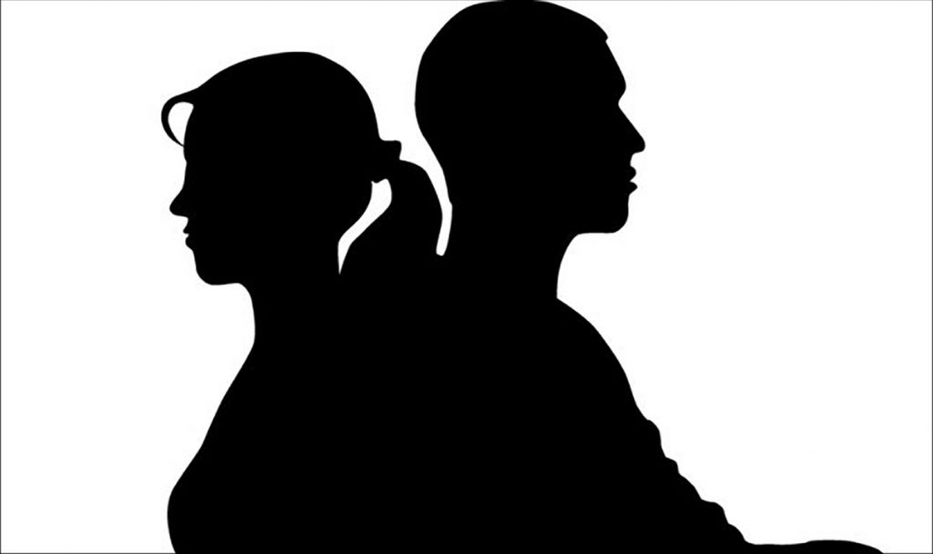 Silhouette of two people seated back to back