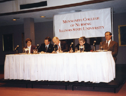 A merger signing ceremony in December 1998 included, from left, Betty Chapman, ISU; Dale Strassheim, BroMenn; David Strand, ISU; Kathleen Hogan, MCN; and Chuck Taylor, ISU.