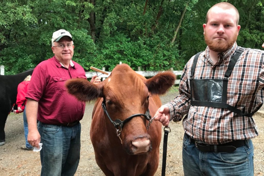 Bill Graff, his son, and a steer.