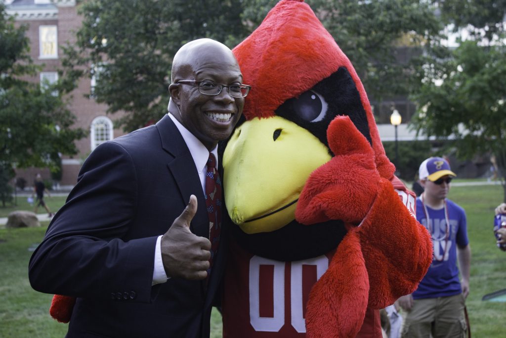 Illinois State Vice President for Student Affairs Levester Johnson poses with Reggie Redbird