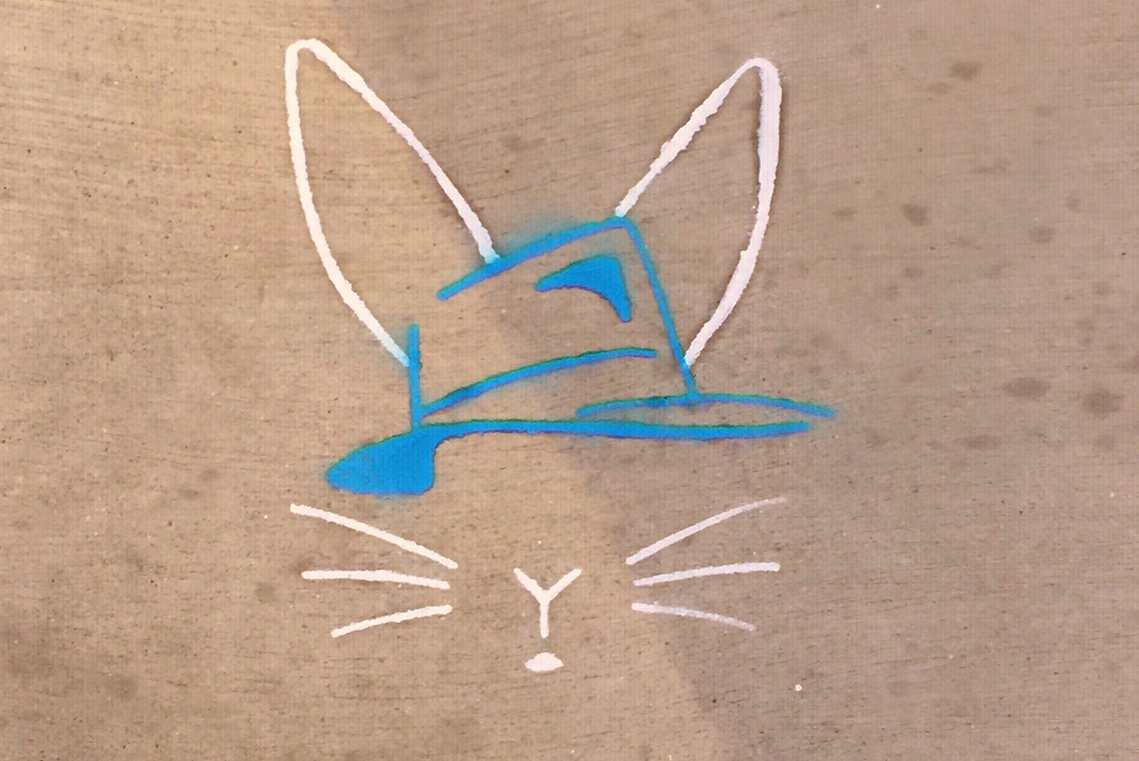 Image from the production poster of a white line-drawn rabbit, wearing a blue hat.