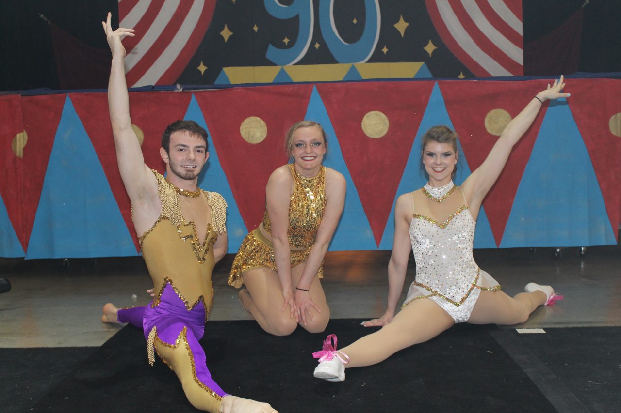 Honors students in the circus pose in costume