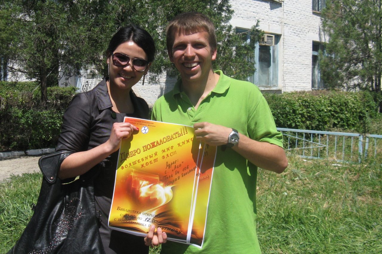 Hotard and woman with a poster