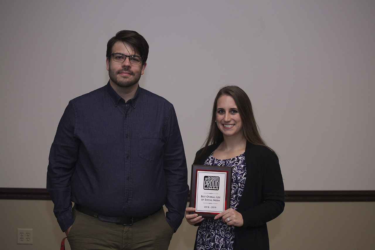 Lauren Morris, on behalf of Illinois State Cheeerleading, accepts the award for Best Overall Use of Social Media from UMC social media coordinator Tyler Emken.
