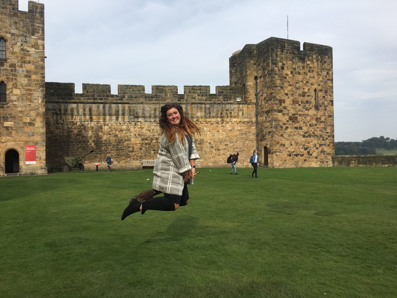 Hannah Lehman jumping in front of castle in Scotland