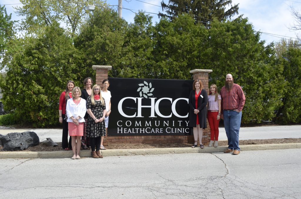 People standing next to CHCC sign