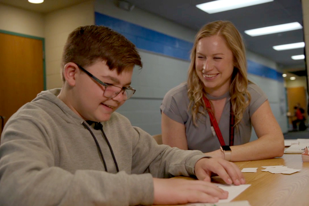 Teacher of the Year Kateri Gullifor assists a visually impaired student